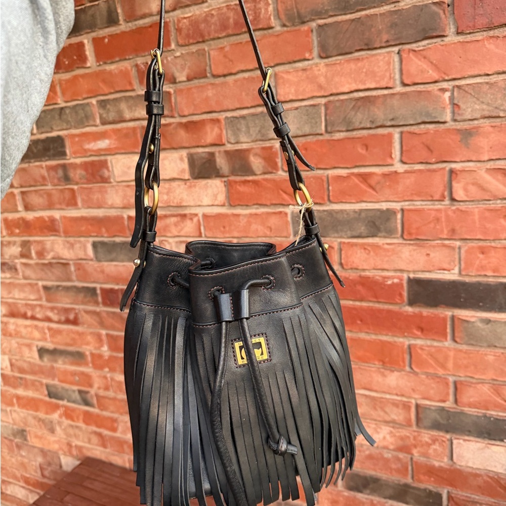 Dooney & Bourke black leather drawstring bucket bag with fringe